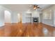 Open-concept living room with hardwood floors, fireplace, and plenty of natural light at 9812 Turtle Walk Ave, Las Vegas, NV 89149