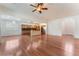 Open-concept living room and kitchen featuring hardwood floors at 9812 Turtle Walk Ave, Las Vegas, NV 89149