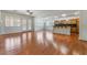 Spacious living area with hardwood floors that connects to the kitchen and has backyard access at 9812 Turtle Walk Ave, Las Vegas, NV 89149