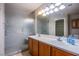 Bathroom featuring a double sink vanity, framed mirror, frosted glass shower, and ample lighting at , Las Vegas, NV 89130