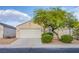 Charming single-story home featuring a two-car garage, desert landscaping, and mature shade tree at , Las Vegas, NV 89130