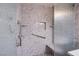 Modern tiled shower with built-in bench, grab bar, and decorative accents, offering a luxurious experience at , Las Vegas, NV 89130