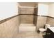Full bathroom with tiled walls, tile floors, and a standard tub and shower at 10 E Bonanza Rd, Las Vegas, NV 89101