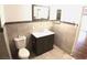 Bathroom featuring tile flooring, tile walls, dark vanity and toilet at 10 E Bonanza Rd, Las Vegas, NV 89101