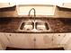 Close-up of a stainless steel kitchen sink with white cabinets at 10 E Bonanza Rd, Las Vegas, NV 89101