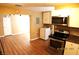 Well-lit kitchen with wood floors, stainless appliances, washer/dryer, and white cabinets at 10 E Bonanza Rd, Las Vegas, NV 89101
