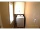 Small laundry area with upper cabinets, tile flooring, and standard size washing machine at 10 E Bonanza Rd, Las Vegas, NV 89101