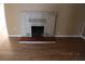 Inviting living room featuring new wood flooring and an elegant, painted brick fireplace at 10 E Bonanza Rd, Las Vegas, NV 89101