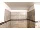Shower stall featuring neutral tile and a contrasting accent stripe at 10 E Bonanza Rd, Las Vegas, NV 89101