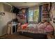 Bedroom with a window, a TV, and anime posters on the walls at 10049 Fragile Fields St, Las Vegas, NV 89183