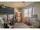 Bedroom with a window, a bed, a dresser, and two guitars at 10049 Fragile Fields St, Las Vegas, NV 89183