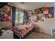 Bedroom with a window, a desk, and anime posters on the walls at 10049 Fragile Fields St, Las Vegas, NV 89183