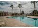 Enjoy the sparkling community pool surrounded by palm trees and lounge chairs, perfect for relaxation at 10049 Fragile Fields St, Las Vegas, NV 89183
