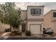 Charming two-story home with a one-car garage and neutral stucco facade, complemented by a tidy front yard and mature tree at 10049 Fragile Fields St, Las Vegas, NV 89183