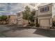 Attractive townhouse elevation with attached garage, desert landscaping, and street parking at 10049 Fragile Fields St, Las Vegas, NV 89183