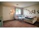 Bright living room with a comfortable sofa, decorative mirrors, and a cozy rug on a wood floor at 10049 Fragile Fields St, Las Vegas, NV 89183