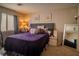 Cozy main bedroom with a plush bed, soft lighting, and carpet flooring at 10049 Fragile Fields St, Las Vegas, NV 89183