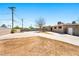 Spacious backyard featuring a large concrete area, block wall fencing, and a covered patio at 1020 Baker Ave, Las Vegas, NV 89108