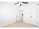 Bedroom featuring light wood-look floors, multiple doors and neutral paint at 1020 Baker Ave, Las Vegas, NV 89108
