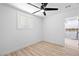 Cozy bedroom with ceiling fan, natural light, and bathroom access at 1020 Baker Ave, Las Vegas, NV 89108
