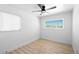 Bedroom with a ceiling fan, window with blinds, and light wood-look flooring at 1020 Baker Ave, Las Vegas, NV 89108