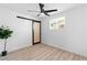 Clean bedroom with a sliding barn door, ceiling fan, and new flooring at 1020 Baker Ave, Las Vegas, NV 89108