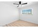 Bright bedroom featuring a ceiling fan, window, and light wood-look flooring at 1020 Baker Ave, Las Vegas, NV 89108