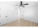 Clean bedroom featuring ceiling fan, wood floors, and crisp white walls at 1020 Baker Ave, Las Vegas, NV 89108