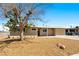 Charming single-story home featuring a gravel front yard and a mature shade tree at 1020 Baker Ave, Las Vegas, NV 89108
