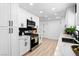 Well-lit kitchen with quartz countertops, stainless steel oven and microwave, and white cabinets at 1020 Baker Ave, Las Vegas, NV 89108