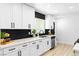 Modern kitchen boasts white cabinets, sleek black hardware, and stylish black subway tile backsplash at 1020 Baker Ave, Las Vegas, NV 89108