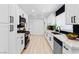 Bright, updated kitchen with white cabinets, stainless steel appliances, and black subway tile backsplash at 1020 Baker Ave, Las Vegas, NV 89108