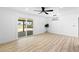 Bright living room with ceiling fan, sliding doors to yard, and wood-look flooring at 1020 Baker Ave, Las Vegas, NV 89108