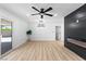 Spacious living room featuring sliding glass doors, recessed lights, and black accent wall at 1020 Baker Ave, Las Vegas, NV 89108