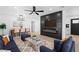Cozy living room boasts fireplace, ceiling fan, and seamlessly connects to the dining area at 1020 Baker Ave, Las Vegas, NV 89108