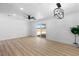 Bright, open living room with sliding glass doors, ceiling fan, modern light fixture, and wood floors at 1020 Baker Ave, Las Vegas, NV 89108