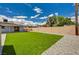 The backyard presents a well-maintained lawn, bordered by gravel and a privacy wall at 108 Prince Ln, Las Vegas, NV 89110