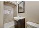 This well-lit bathroom features a single sink vanity with storage and tiled shower at 108 Prince Ln, Las Vegas, NV 89110