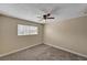 A neutral bedroom has plush carpet, natural light, and a ceiling fan at 108 Prince Ln, Las Vegas, NV 89110