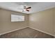 This neutral bedroom features plush carpet, a modern fan and an airy, sunlit feel at 108 Prince Ln, Las Vegas, NV 89110