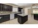 Features in this kitchen include an island, stainless appliances, light wood floor and dark wood cabinets at 108 Prince Ln, Las Vegas, NV 89110