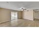 Inviting living room featuring wood floors, ceiling fan, and sliding glass doors at 108 Prince Ln, Las Vegas, NV 89110
