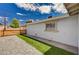This side yard offers a mix of gravel, artificial turf, and a wooden fence at 108 Prince Ln, Las Vegas, NV 89110