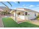 This backyard features a covered patio and a small pool surrounded by lush turf at 116 Crescent Bay St, Henderson, NV 89012