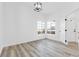 Spacious, airy bedroom with large window, light grey floors and modern lighting fixture at 116 Crescent Bay St, Henderson, NV 89012