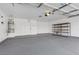 Spacious garage with painted floors, water heater, and shelving for storage at 116 Crescent Bay St, Henderson, NV 89012