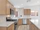 Stylish kitchen with modern appliances, quartz countertops, and natural-colored cabinetry at 116 Crescent Bay St, Henderson, NV 89012