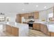 Modern kitchen featuring a large island, stainless steel appliances, and stylish backsplash at 116 Crescent Bay St, Henderson, NV 89012
