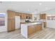 This modern kitchen features an island with a waterfall countertop and stainless steel appliances at 116 Crescent Bay St, Henderson, NV 89012