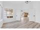 Bright living room with hardwood floors and a view into the eat-in kitchen through double doors at 116 Crescent Bay St, Henderson, NV 89012